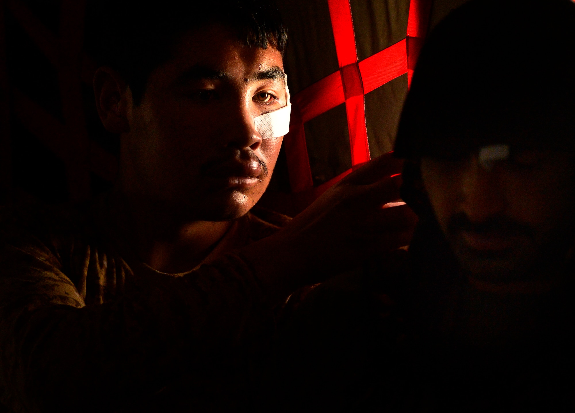 Afghan National Army soldiers assist each other with bandages and headgear during a C-130H1 Hercules flight, Camp Bastion, Afghanistan, May 19, 2014. The Afghan aircrew successfully loaded the human remains, ANA soldiers and other personnel during the casualty evacuation mission. The aircrew assisted 16 injured patients onto stretchers and into safe positions during the flight.  (U.S. Air Force photo by Staff Sgt. Vernon Young Jr.)