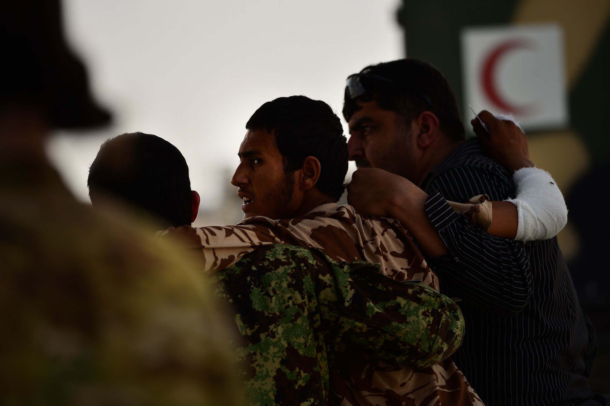 Afghan National Army soldiers assist each other to board a C-130H1 Hercules during a casualty evacuation mission, Camp Bastion, Afghanistan, May 19, 2014. Sixteen injured ANA soldiers were transported to receive medical care to their injuries. (U.S. Air Force photo by Staff Sgt. Vernon Young Jr.)