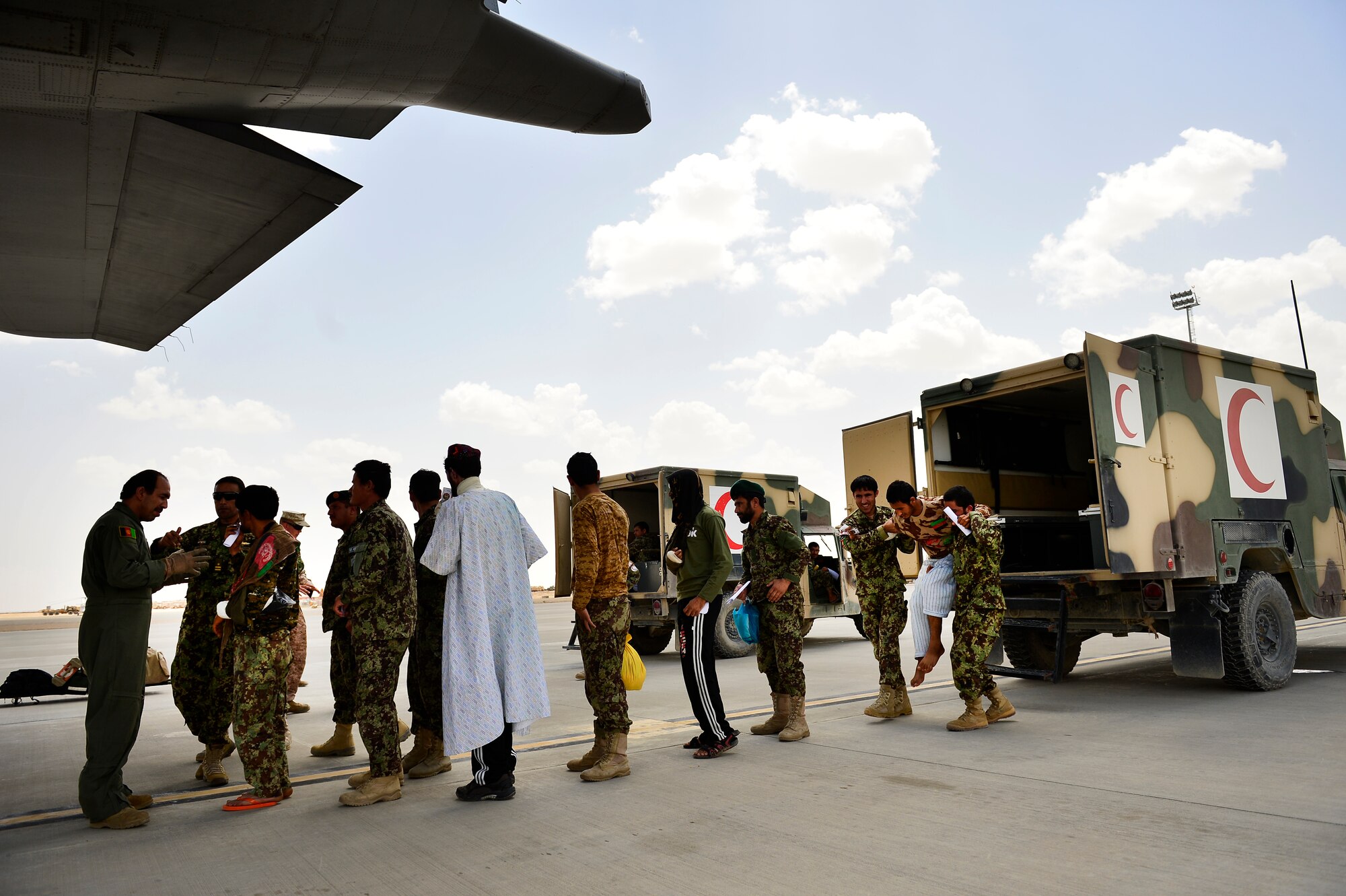 Sgt. Shanawaz Nabi Zada, Afghan Air Force loadmaster, briefs Afghan National Army soldiers prior to loading them on a C-130H1 Hercules, Camp Bastion, Afghanistan, May 19, 2014. As a loadmaster, Nabi Zada is responsible for briefing Afghan passengers on safety, enforcing in-flight standards and evenly distributing weight throughout the aircraft.  Nabi Zada has been trained by advisors assigned to the 438th Air Expeditionary Advisory Squadron. (U.S. Air Force photo by Staff Sgt. Vernon Young Jr.)
