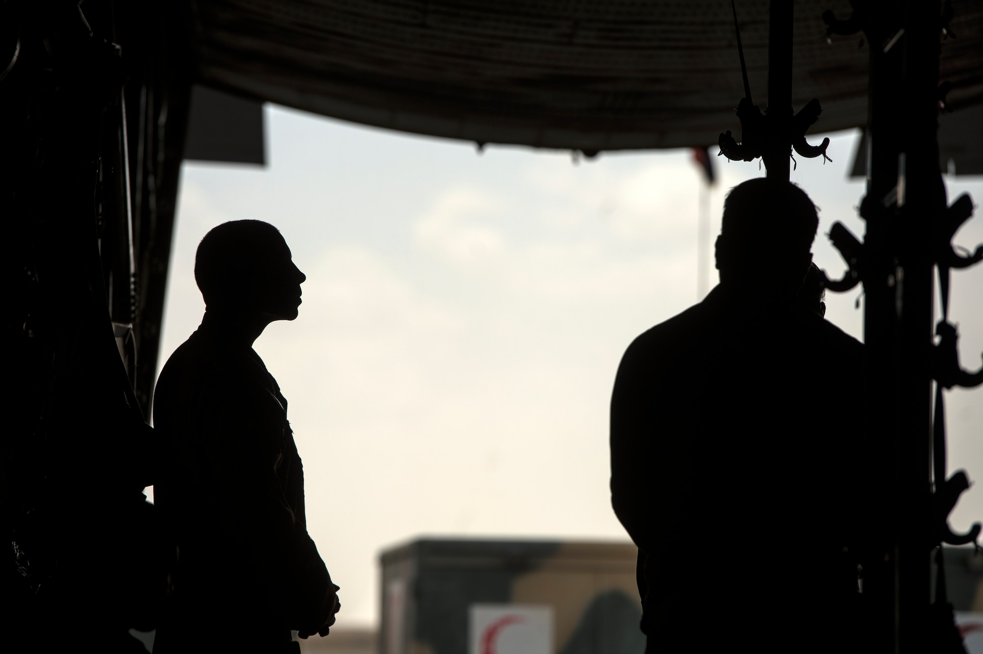 Senior Master Sgt. Mike Falcho, 538th Air Expeditionary Advisory Squadron, squadron superintendent, pauses as Afghan National Army soldiers render final salutes to their fallen during a casualty evacuation mission, Camp Bastion, Afghanistan, May 19, 2014. Afghan load masters led the CASEVAC mission involving Afghans injured during combat operation. Falcho, a South Park, Pennsylvania native, is deployed from the 62nd Airlift Squadron, Little Rock, Arkansas. (U.S. Air Force photo by Staff Sgt. Vernon Young Jr.)