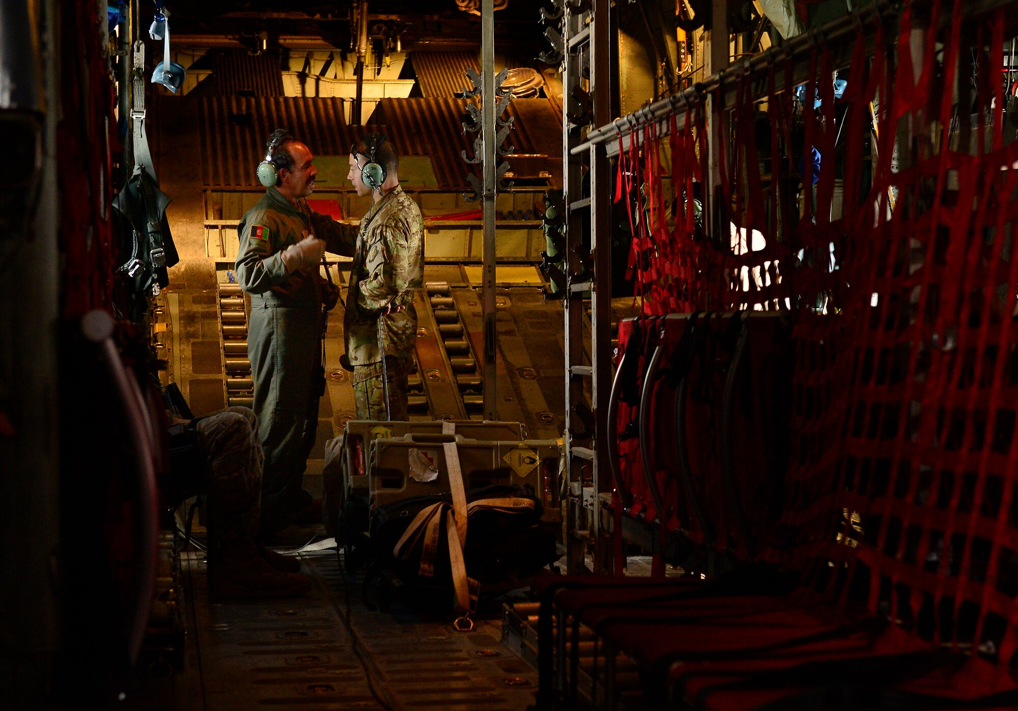 Senior Master Sgt. Mike Falcho, 538th Air Expeditionary Advisory Squadron, squadron superintendent, advises and encourages, Sgt. Shanawaz Nabi Zada, Afghan Air Force load master, during an Afghan National Army casualty evacuation mission, Kabul, Afghanistan, May 19, 2014. Afghan load masters led the CASEVAC mission involving Afghans injured during combat operation. Falcho, a South Park,Pennsylvania native, is deployed from the 62nd Airlift Squadron, Little Rock, Arkansas. (U.S. Air Force photo by Staff Sgt. Vernon Young Jr.)