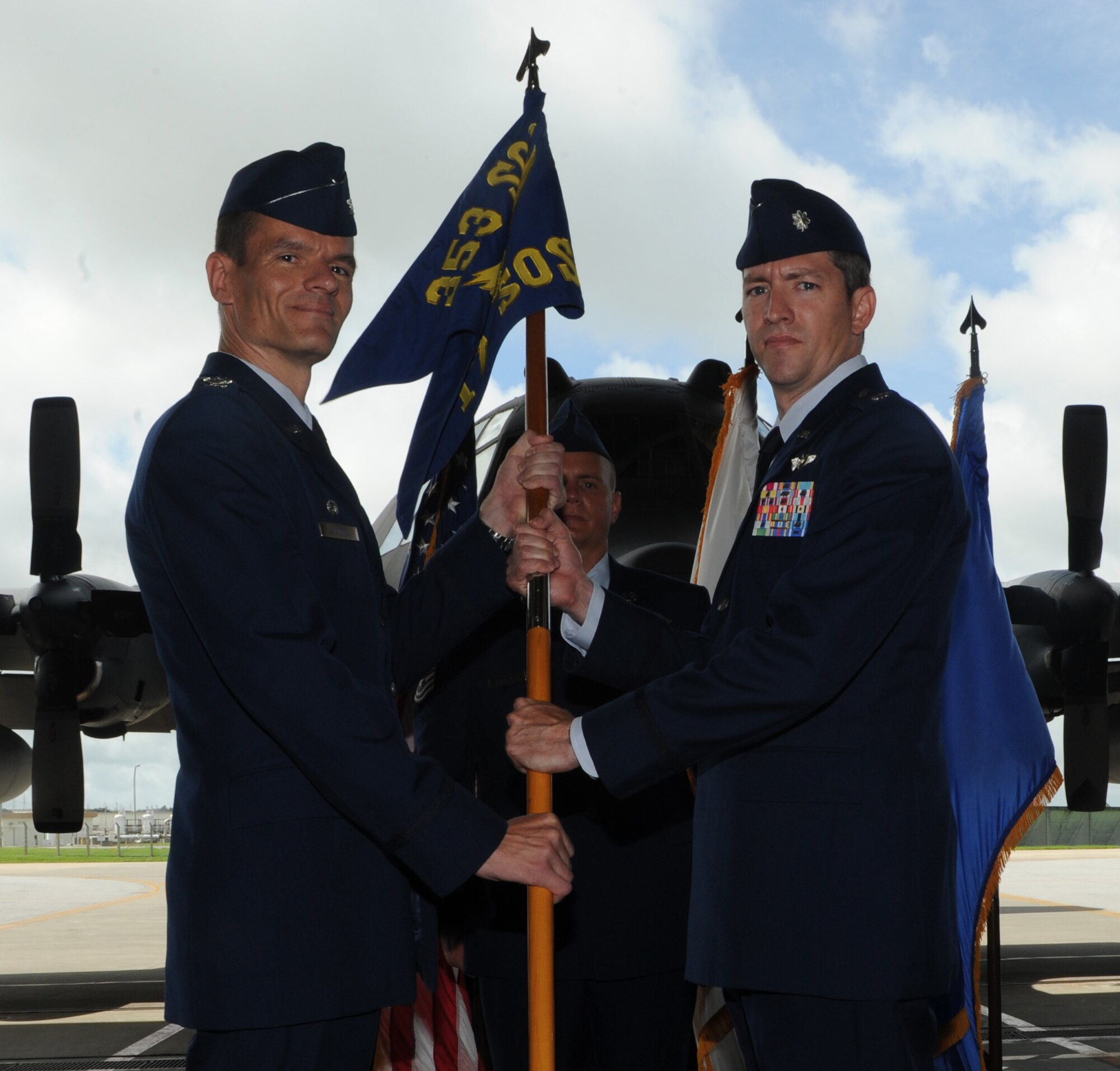 U.S. Air Force Col. Benjamin Maitre, 353rd Special Operations Group commander, passes the guidon to Lt. Col. Nathan T. Colunga, 17th Special Operations Squadron commander, during the 17th SOS change of command on Kadena Air Base, Japan, June 17, 2014. The passing of the guidon is the exact moment that the new commander officially takes responsibility of the new unit. The 17th SOS employs MC-130P aircraft and highly trained, agile Air Commandos to rapidly execute and support special operations missions with precise and reliable navigation, airdrop into austere landings, and provide multi-mission refueling to achieve combatant commander objectives. (U.S. Air Force photo by Airman 1st Class Stephen G. Eigel)