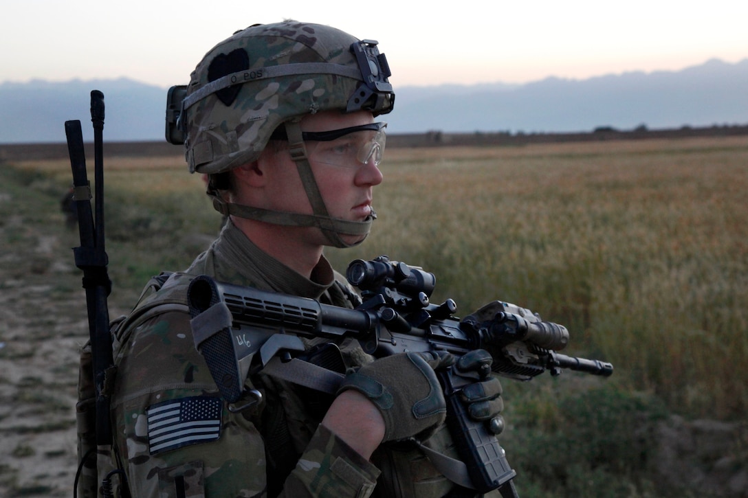 U.S. Army 1st Lt. Matthew White provides security while on patrol through Petawa village in Afghanistan's Parwan province, June 13, 2014. White is assigned to the 101st Airborne Division's Company A, 1st Battalion, 2nd Brigade Combat Team, Task Force Strike.