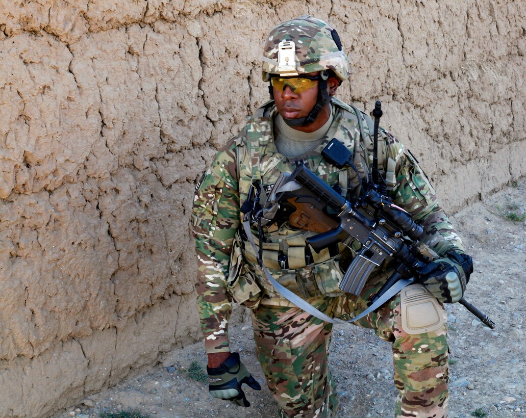 U.S. Army Capt. Rodney Freeman provides security while on patrol through Petawa village in Afghanistan's Parwan province, June 13, 2014. Freeman is assigned to the 101st Airborne Division's Company A, 1st Battalion, 2nd Brigade Combat Team, Task Force Strike.
