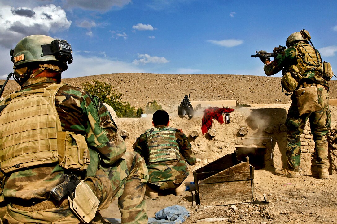 A U.S. Special Operations Forces team member fires at an enemy sniper position during a clearing operation in Chak district in Afghanistan's Wardak province, Oct. 9, 2011. Team members and Afghan commandos conducted the operation to disrupt insurgent activity in the area.  
