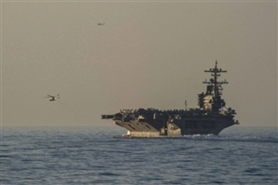 The aircraft carrier USS George H.W. Bush transits the Strait of Hormuz, June 14, 2014. Defense Secretary Chuck Hagel ordered the carrier to move from the North Arabian Sea into the Arabian Gulf to provide President Barack Obama additional flexibility should military options be required to protect American lives, citizens and interests in Iraq, Pentagon Press Secretary Navy Rear Adm. John Kirby said.