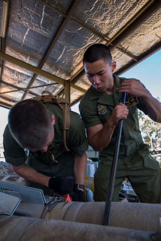 Cpl. Phillip Louie, right, assists Lance Cpl. Joshua Jensen, in placing the fin on a Mark-83 general purpose bomb as part of Exercise Southern Frontier 2014 aboard Royal Australian Air Force Base Tindal, Australia, June 9. Louie and Jensen are aviation ordnance technicians with Marine Aviation Logistics Squadron 12. Southern Frontier is an annual bilateral training exercise between the RAAF and the United States Marine Corps with a primary focus on offensive air support and enhanced military interoperability. Ordnance Marines with MALS-12 prepared the ordnance slated to be used by Marine All-Weather Fighter Attack Squadron 242 pilots during SF14.     