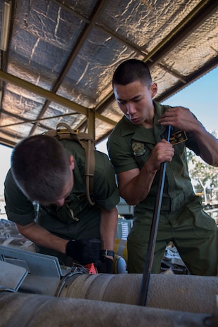 Cpl. Phillip Louie, right, assists Lance Cpl. Joshua Jensen, in placing the fin on a Mark-83 general purpose bomb as part of Exercise Southern Frontier 2014 aboard Royal Australian Air Force Base Tindal, Australia, June 9. Louie and Jensen are aviation ordnance technicians with Marine Aviation Logistics Squadron 12. Southern Frontier is an annual bilateral training exercise between the RAAF and the United States Marine Corps with a primary focus on offensive air support and enhanced military interoperability. Ordnance Marines with MALS-12 prepared the ordnance slated to be used by Marine All-Weather Fighter Attack Squadron 242 pilots during SF14.     