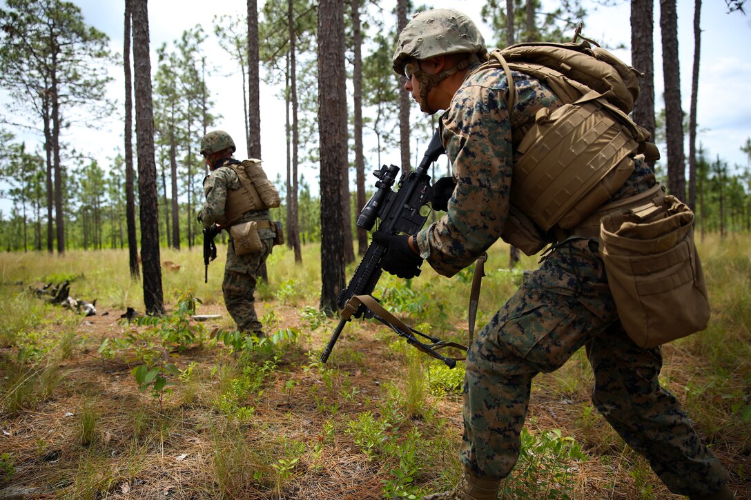 Marines with Kilo Company, Battalion Landing Team 3rd Battalion, 6th Marine Regiment, 24th Marine Expeditionary Unit, move into position as they prepare to assault Combat Town at Camp Lejeune, N.C., June 7, 2014. The assault was part of Kilo Company’s mechanized raid package in preparation for the unit’s deployment with the 24th MEU at the end of the year. (U.S. Marine Corps photo by Lance Cpl. Joey Mendez)