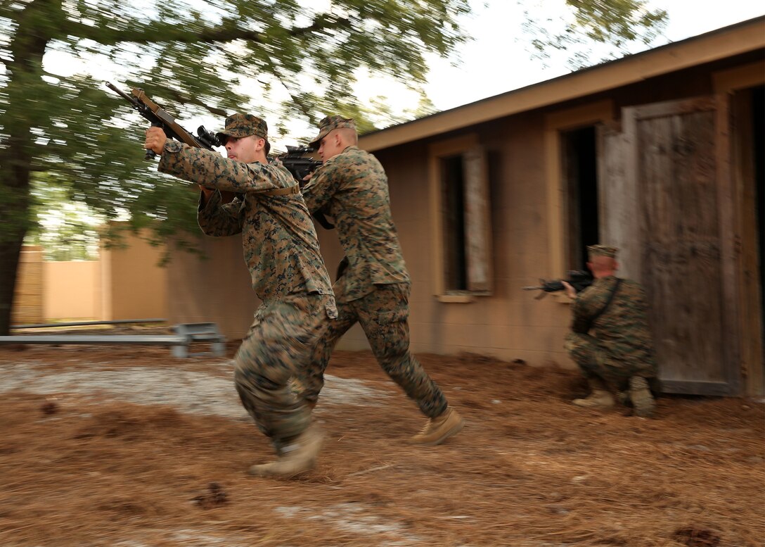 Marines with Kilo Company, Battalion Landing Team 3rd Battalion, 6th Marine Regiment, 24th Marine Expeditionary Unit, move building-to-building during a mechanized raid rehearsal in Combat Town at Camp Lejeune, N.C., June 7, 2014. The rehearsal was part of the company’s mechanized raid package in preparation for the unit’s deployment with the 24th MEU at the end of the year. (U.S. Marine Corps photo by Lance Cpl. Joey Mendez)
