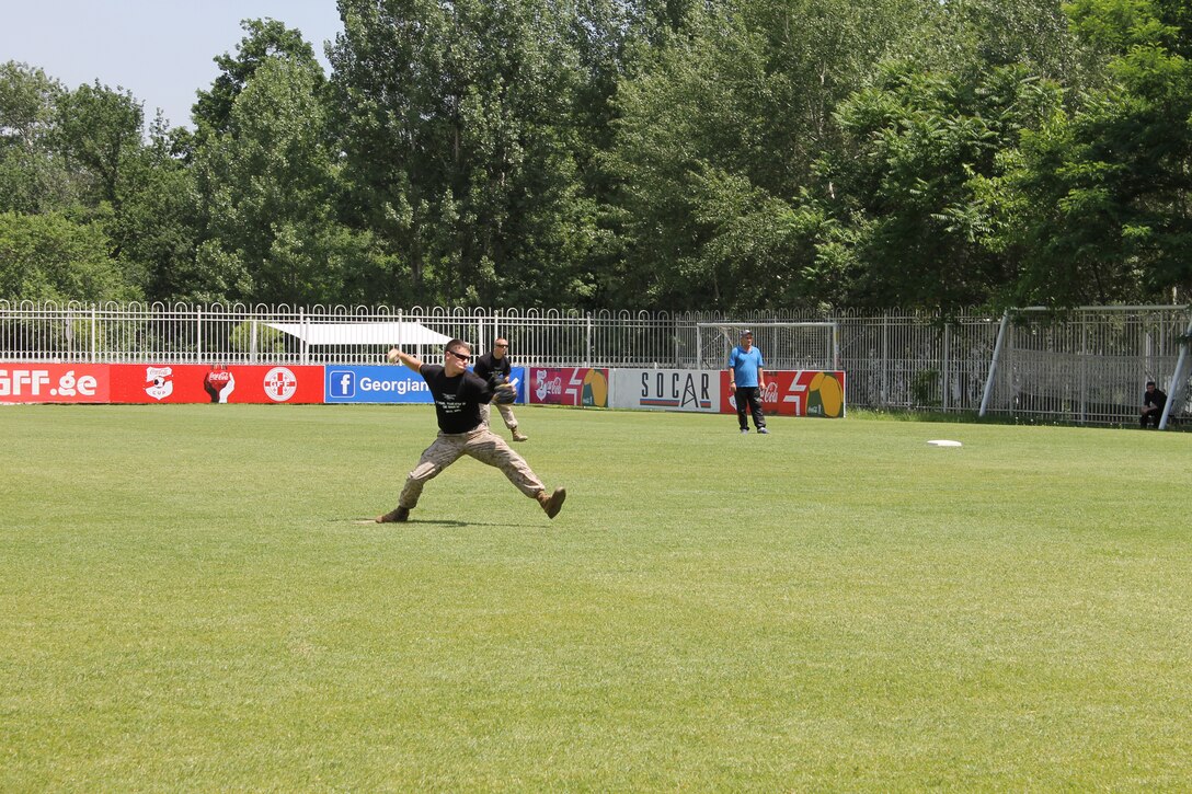 Sgt. Conor Dougherty, a ground radio repairman with the Georgia Deployment Program-ISAF, throws to first base during a baseball game at Meskhi Stadium, located in the Vake district of Tbilisi, Georgia, between the US Marines and the Georgian National Baseball Team, hosted by the U.S. Embassy and the Georgian Ministry of Defense to raise awareness of the Georgian Wounded Warrior Program, May 31. Through GDP-I, the Georgian military has trained with Marines to serve alongside U.S. forces and other partner nations for support to the International Security Assistance Force in Afghanistan.