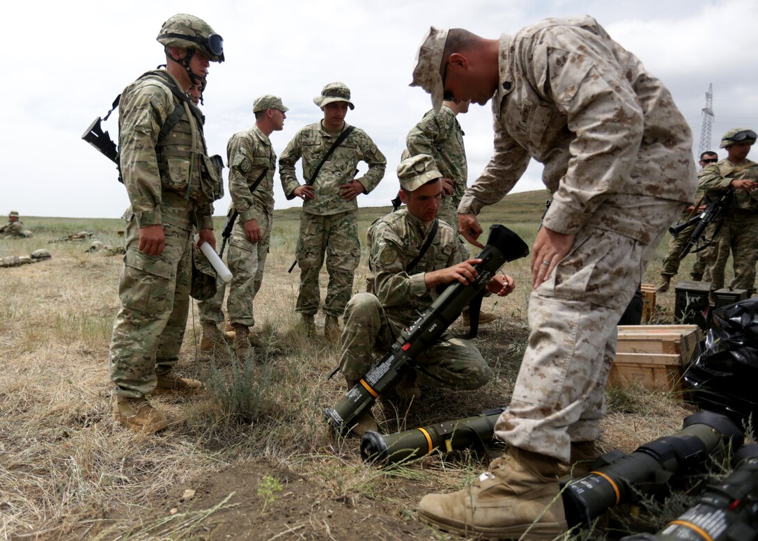 U.S. Marine Corps Gunnery Sgt. Matthew J. Richey of Black Sea Rotational Force 14 from 3rd Battalion, 8th Marine Regiment, explains the components and functionality of the AT-4 light anti-armor weapon to Georgian soldiers during a live-fire exercise at Agile Spirit 14, Vaziani Training Area, Georgia, June 11, 2014. This fourth iteration of the Agile Spirit exercise will run until 21 June, and includes live-fire training and a field exercise with both countries. The exercise is conducted with the Georgian Armed Forces within the Vaziani Training Area to increase partnership capacity and interoperability between the two nations. (U.S. Marine Corps photo by Lance Cpl. Samantha A. Barajas, 2nd Marine Division, Combat Camera/ Released)