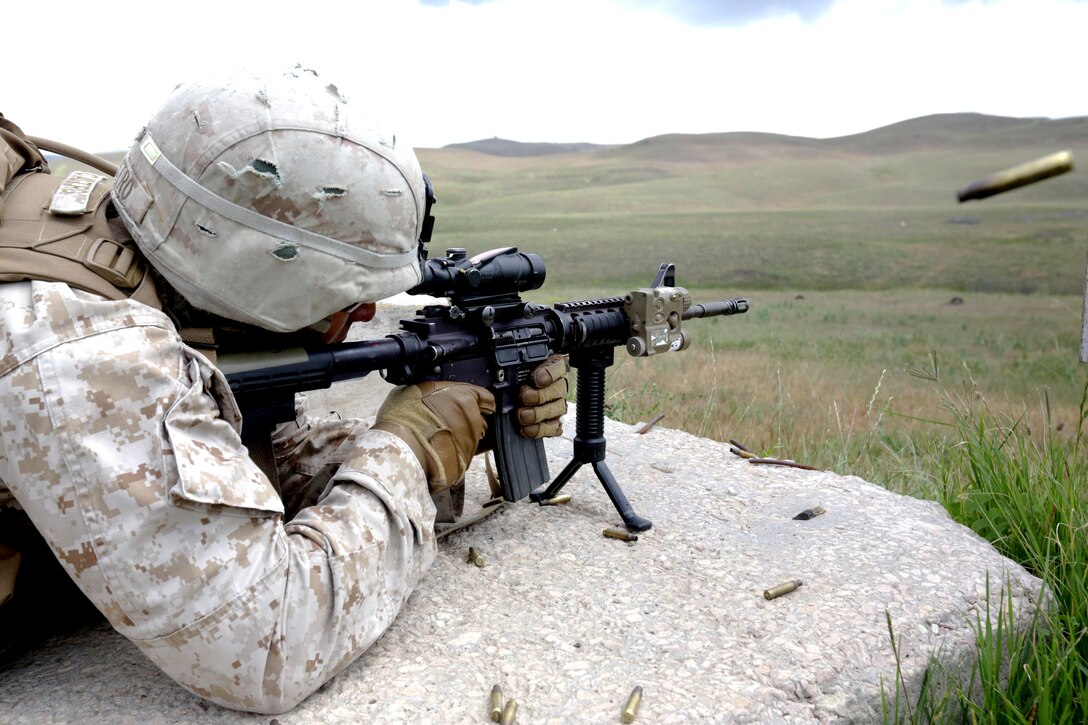 U.S. Marine Corps Cpl. Daniel Castro of Black Sea Rotational Force 14 from 3rd Battalion, 8th Marine Regiment, sights in and fires his M4 service rifle on target during a live-fire exercise as part of exercise Agile Spirit 14 at Vaziani Training Area, Georgia, June 11, 2014. This fourth iteration of the Agile Spirit exercise will run until 21 June, and includes live-fire training and a field exercise with both countries. The exercise is conducted with the Georgian Armed Forces within the Vaziani Training Area to increase partnership capacity and interoperability between the two nations. (U.S. Marine Corps photo by Lance Cpl. Samantha A. Barajas, 2nd Marine Division, Combat Camera/ Released)