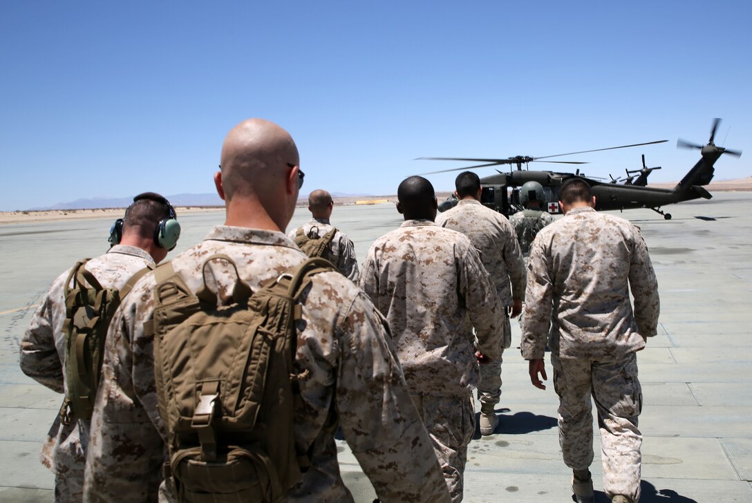 Marines walk out to a UH-60 Blackhawk helicopter operated by the 1st Battalion, 171st Aviation Regiment, New Mexico Army National Guard in a joint service exercise for preparation, situational awareness and medic familiarization during Integrated Training Exercise 4-14 aboard Marine Air Ground Combat Center, Twentynine Palms California, June 13, 2014. ITX 4-14 is the largest annual U.S. Marine Corps Reserve training exercise, which helps refine skills necessary to seamlessly integrate with active duty counterparts as well as operate as a complete MAGTF. (U.S. Marine photo by Sgt. Adwin Esters/Released)