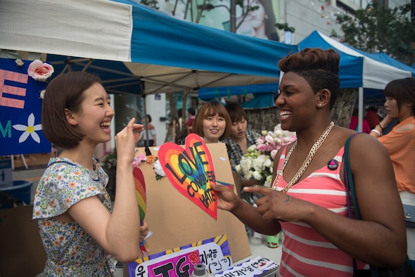 Senior Airman Kayla Dale talks at an information booth at the Gay Pride Parade June 7, 2014, in Seoul, South Korea. Dale, a 51st Maintenance Squadron non-destructive inspector, has been in the Air Force since 2011, first working at Langley Air Force Base, Va., before moving to Osan Air Base in April of 2014. (U.S. Air Force photo/Staff Sgt. Jake Barreiro)