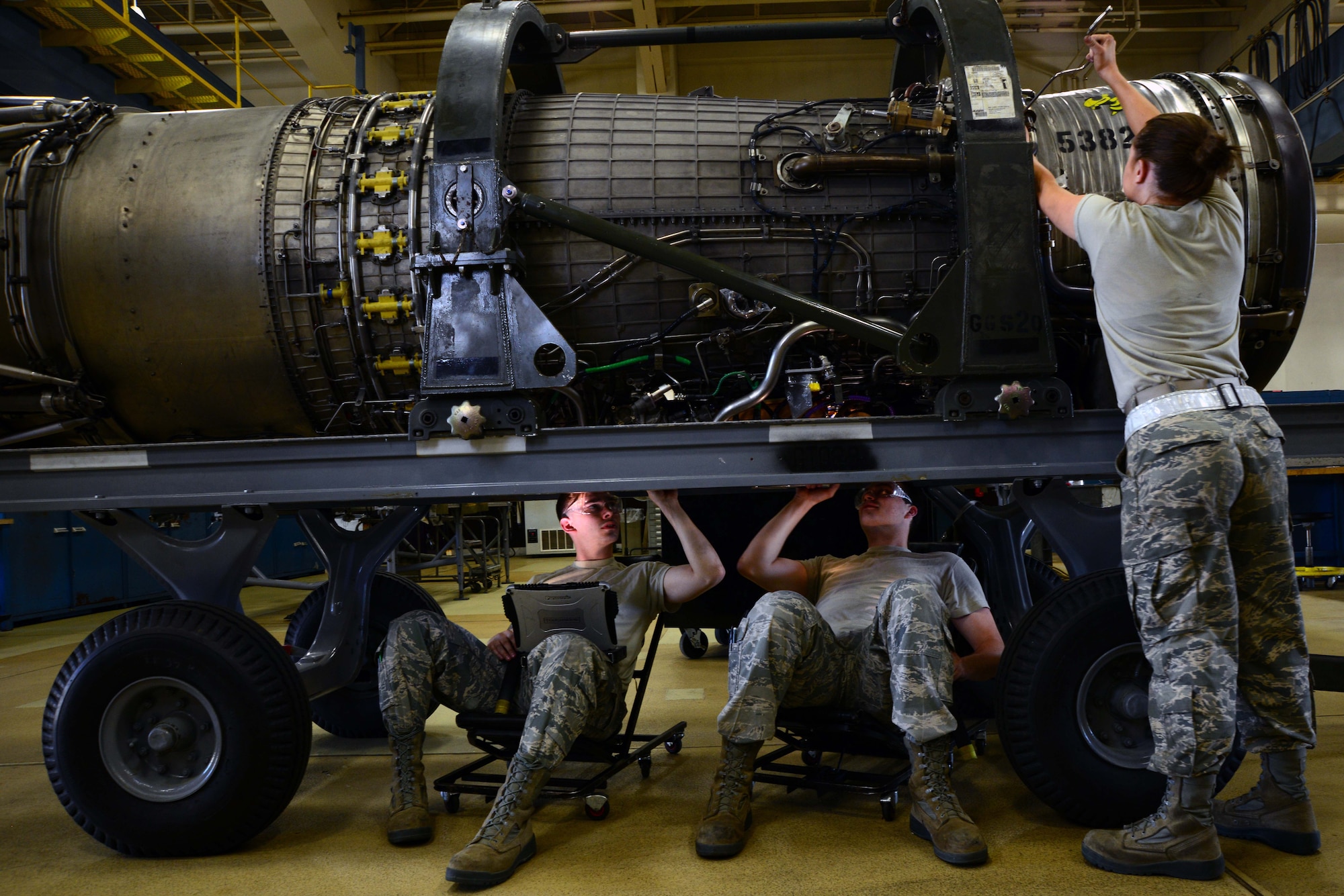 From left: Airmen 1st Class Tyler Susskind, Robert Reindl and Airman Madison Mitchell, 35th Maintenance Squadron aerospace propulsion journeymen, put the finishing touches on an F-16 Fighting Falcon engine June 6, 2014, at Misawa Air Base, Japan. Aerospace Propulsion is known as “props,” and is responsible for all engine maintenance for not only Misawa AB, but Osan and Kunsan Air Bases, South Korea. (U.S. Air Force photo/Senior Airman Derek VanHorn)