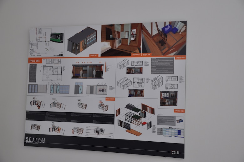 A large poster shows the construction process of emergency prototype housing inside one of three units constructed by the New York City Office of Emergency Management and Department of Design and Construction. Displayed in a ribbon-cutting ceremony June 10, 2014, the units are designed to resettle large numbers of people quickly in an urban area in the event of a major coastal storm or disaster. The Army Corps of Engineers is serving as project manager. 