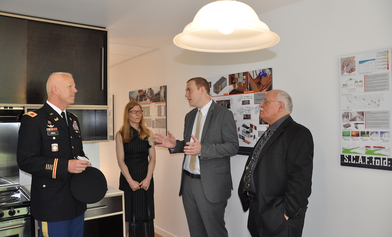 Michael Hogg, project manager, U.S. Army  Corps of Engineers, NY District (second from right), explains interior design features of emergency prototype housing to Col. Paul Owen (left), Commander of the NY District, on June 10, 2014. The units are designed to resettle large numbers of people quickly in an urban area in the event of a major coastal storm or disaster. At extreme right is Nicholas Peluso, director, constructability and bid packaging, NYC Dept. of Design and Construction; in background is Cynthia Barton, project manager, NYC Office of Emergency Management. The Army Corps of Engineers is serving as project manager. 
