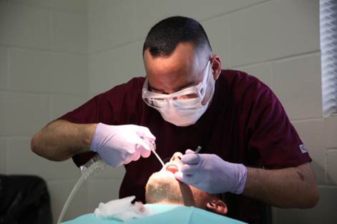 KAUAI, Hawaii - Petty Officer 2nd Class Hooman Shahidy a dental technician with 4th Dental Battalion, 4th Marine Logistics Group, works on Tim Holcombe, a patient being seen, at no cost, by dental personnel during Innovative Readiness Training exercise Tropic Care 2014. TC14 is part of a civil and joint military program to improve military readiness while simultaneously providing quality services to communities throughout America.  
