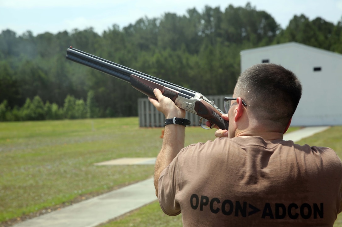 Maj. Kevin J. Stepp tracks a clay pigeon during a skeet shoot at the Marine Corps Air Station Cherry Point's Skeet Range, June 5, 2014. Stepp is the operations officer of Marine Wing Communications Squadron 28. The Marines of MWCS-28 assemble once a month outside of work in a relaxed environment to reinforce the warrior spirit and build unit cohesion.