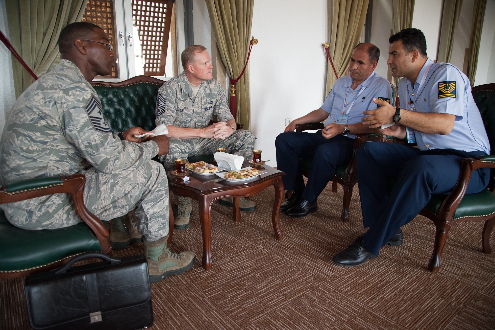 Chief Master Sgt. of the Air Force James A. Cody and Chief Master Sgt. James Davis discuss the role of NCOs with Turkish air force chief master sergeants, including Chief Master Sergeant of the Turkish air force Nazmi Harmanci (left) during the Turkish air force International NCO Symposium, June 9, 2014, in Istanbul, Turkey. Cody and Davis attended the symposium, which brought together the top senior enlisted Airmen from 20 air forces around the world to exchange ideas and enhance interoperability. Davis is the U.S. Air Forces in Europe and Air Forces Africa Command chief master sergeant. (U.S. Air Force photo/Senior Master Sgt. Lee E. Hoover Jr.)