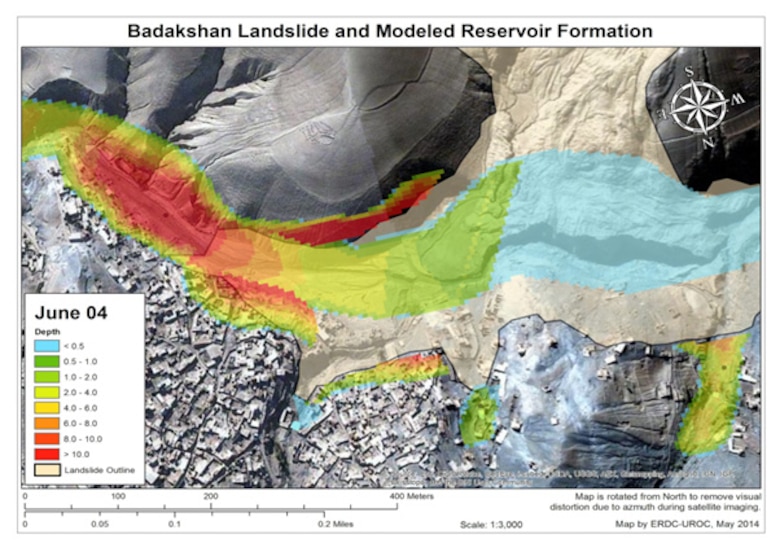 The photo depicts the mudslide area (tan color), the village and the modeled reservoir (in red, green and blue). The HEC-HMS model was used to predict, if nothing was done, the water would overtop the mudslide on or about June 4.