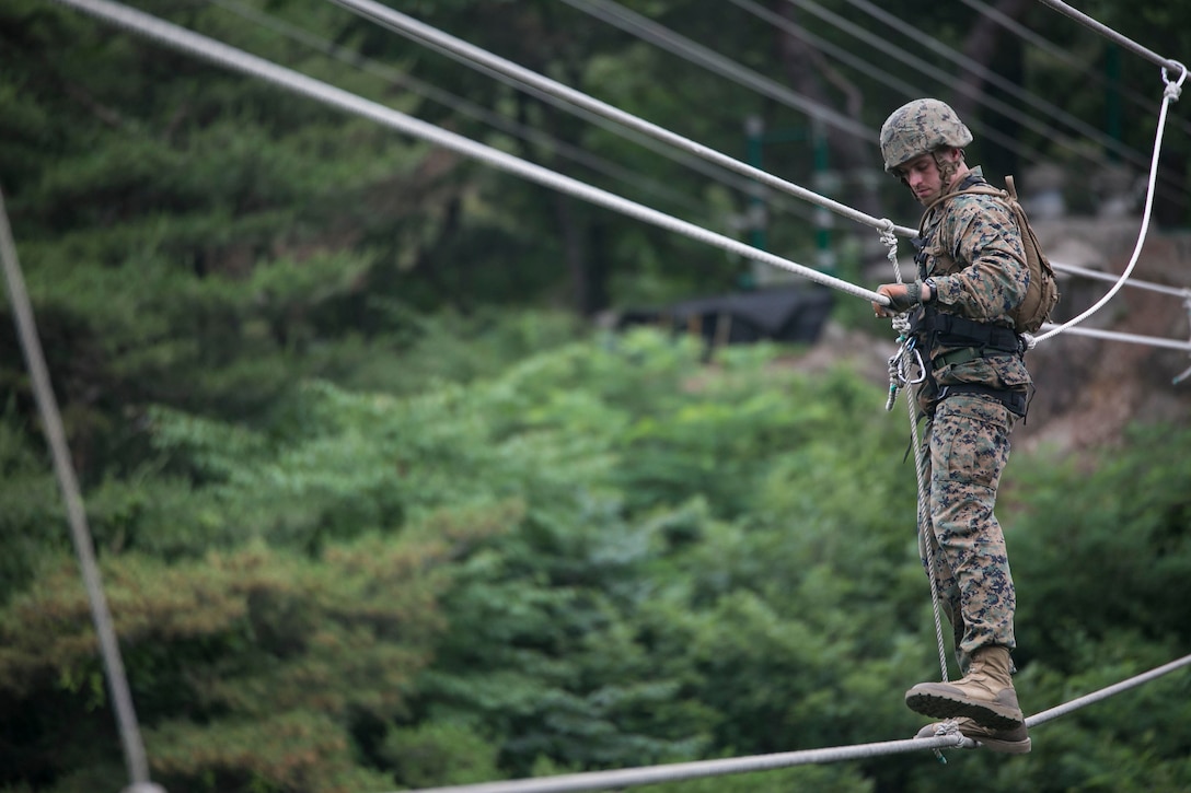 U.S. Marine 1st Lt. Kelton M. Miller makes his way across a rope bridge June 9 as part of a Mountain Warfare Training Course at the 1st ROK Marine Division Mountain Warfare Training Center in Pohang, Republic of Korea. The U.S. Marines are in the Republic of Korea to take part in Korean Marine Exchange Program 14-8. KMEP is a series of continuous combined training exercises designed to enhance the ROK-U.S. alliance, promote stability on the Korean Peninsula and strengthen ROK-U.S. military capabilities and interoperability. Miller is a military police officer with Company B, 3rd Law Enforcement Battalion, III Marine Expeditionary Force Headquarters Group, III MEF. (U.S. Marine Corps photo by Lance Cpl. Drew Tech/Released)