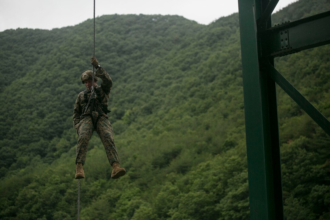 U.S. Marine Sgt. Jeremy Buel rappels down from a platform June 10 as part of a Mountain Warfare Training Course at the 1st ROK Marine Division Mountain Warfare Training Center in Pohang, Republic of Korea. The U.S. Marines are in the Republic of Korea to take part in Korean Marine Exchange Program 14-8. KMEP is a series of continuous combined training exercises designed to enhance the ROK-U.S. alliance, promote stability on the Korean Peninsula and strengthen ROK-U.S. military capabilities and interoperability. Buel is an explosive ordnance disposal technician with 3rd EOD Company, 9th Engineer Support Battalion, 3rd Marine Logistics Group, III Marine Expeditionary Force. (U.S. Marine Corps photo by Lance Cpl. Drew Tech/Released)
