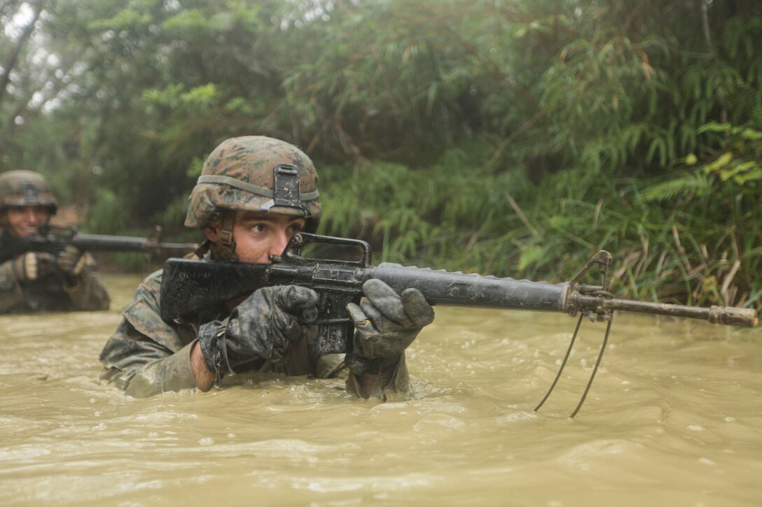 Lance Cpl. Brock A. Lemons  patrols through muddy water during the Jungle Endurance Course at Camp Gonsalves, June 14. Lemons is an infantryman with Company K, Battalion Landing Team 3rd Battalion, 5th Marines, 31st Marine Expeditionary Unit, and a native of Scottsbluff, Nebraska. Multiple obstacles make up the endurance course, which tests physical and mental stamina, as well as unit cohesion. The 31st MEU is the force of choice for the Asia-Pacific region and is the only continuously forward-deployed MEU.