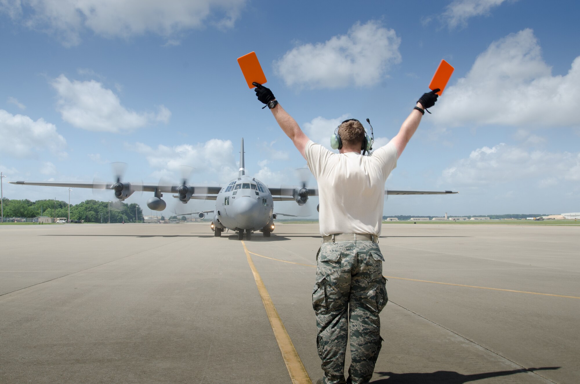 Staff Sgt. Joseph Bigelow, a crew chief for the Kentucky Air National Guard’s 123rd Contingency Response Group, marshals a Kentucky Air National Guard C-130 Hercules during Capstone '14, a homeland earthquake-response exercise at Fort Campbell, Ky., on June 17, 2014. The 123rd CRG is joining with the U.S. Army’s 688th Rapid Port Opening Element to operate a Joint Task Force-Port Opening here from June 16 to 19, 2014. (U.S. Air National Guard photo by Master Sgt. Phil Speck)