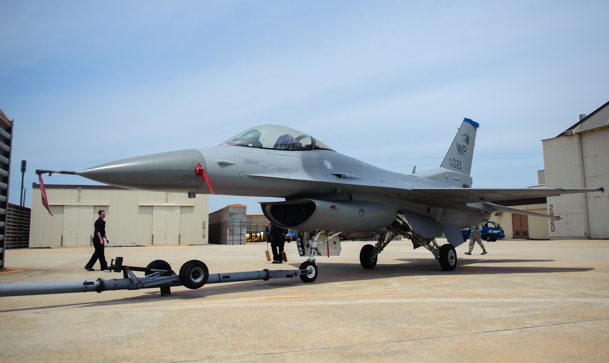 Crew chiefs guide the freshly painted F-16 Fighting Falcon 89-021 after a depot-level paint job at Kunsan Air Base, Republic of Korea, June 16, 2014. Airmen from the 8th Maintenance Squadron corrosion control section completed the first in-house paint job at Kunsan in more than six years after a recent upgrade to the painting facility. (U.S. Air Force photo by Senior Airman Armando A. Schwier-Morales/Released)