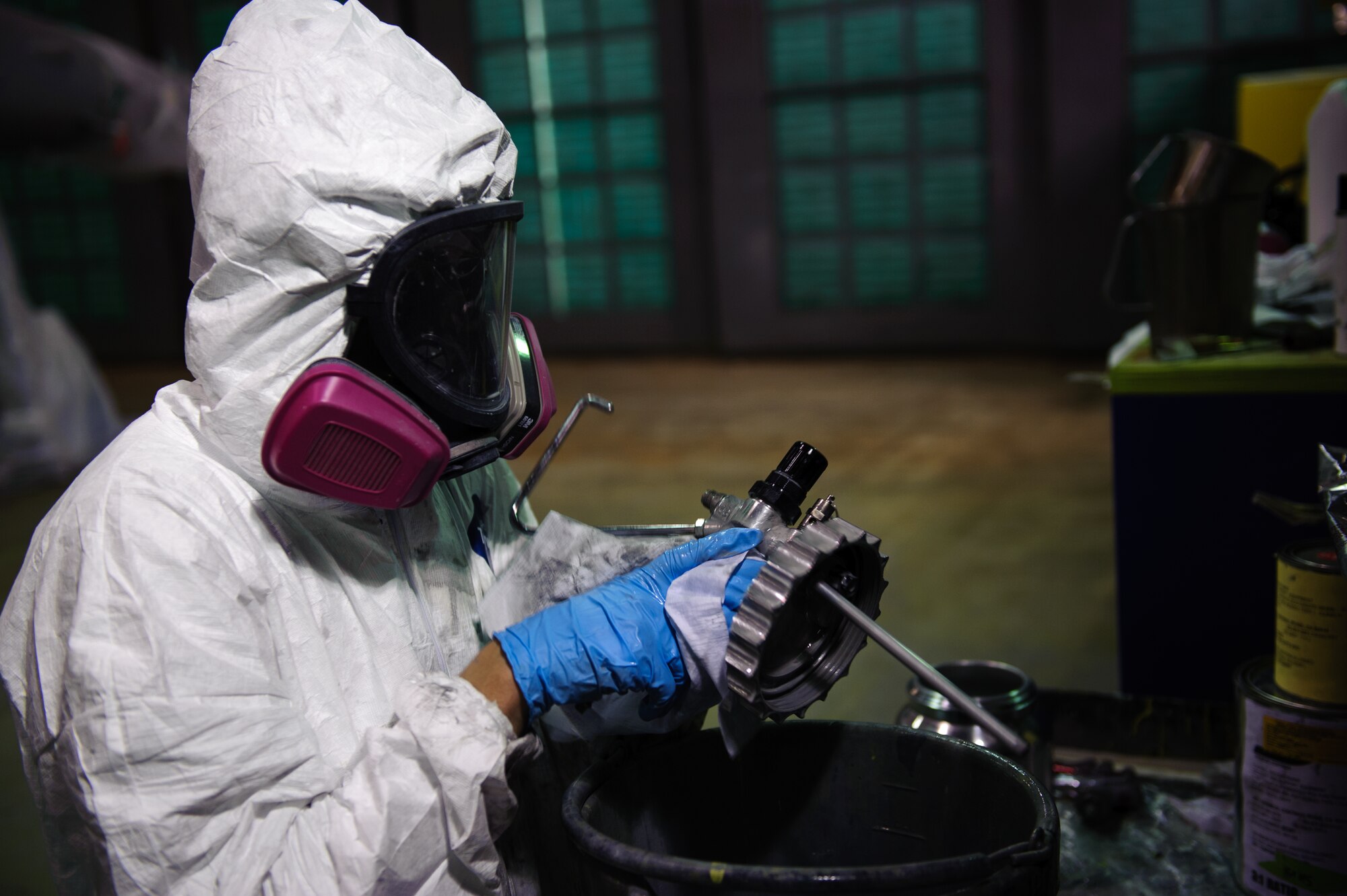 Senior Airman Michael Hudson, 8th Maintenance Squadron Aircraft Structural Maintenance journeyman, cleans his tools after painting an F-16 Fighting Falcon with its first coat during depot-level maintenance at Kunsan Air Base, Republic of Korea. At most bases, the F-16s are sent to a depot for a full paint job. Recently an overhaul was completed on the corrosion shop hanger. This allowed the shop to complete a paint job expected to take 14 days in a depot in 10 days. (U.S. Air Force photo by Senior Airman Armando A. Schwier-Morales/Released)
