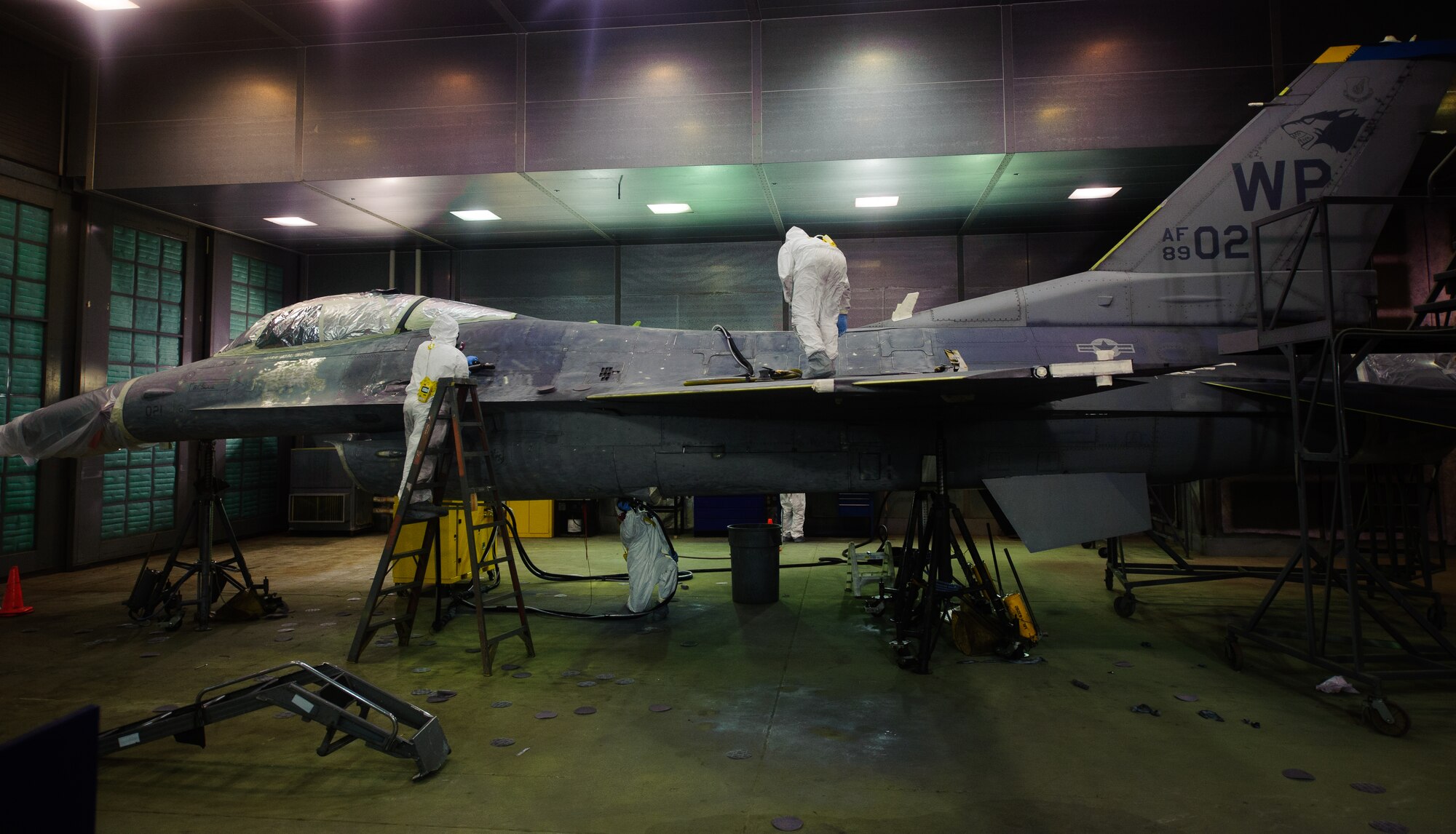 Airmen from the 8th Maintenance Squadron corrosion control section sand and prepare an F-16 Fighting Falcon for a full depot-level paint job at Kunsan Air Base, Republic of Korea, June 4, 2014. Recently an overhaul was completed on the corrosion shop hanger. This allowed the shop to complete a paint job expected to take 14 days in a depot in 10 days. (U.S. Air Force photo by Senior Airman Armando A. Schwier-Morales/Released)
