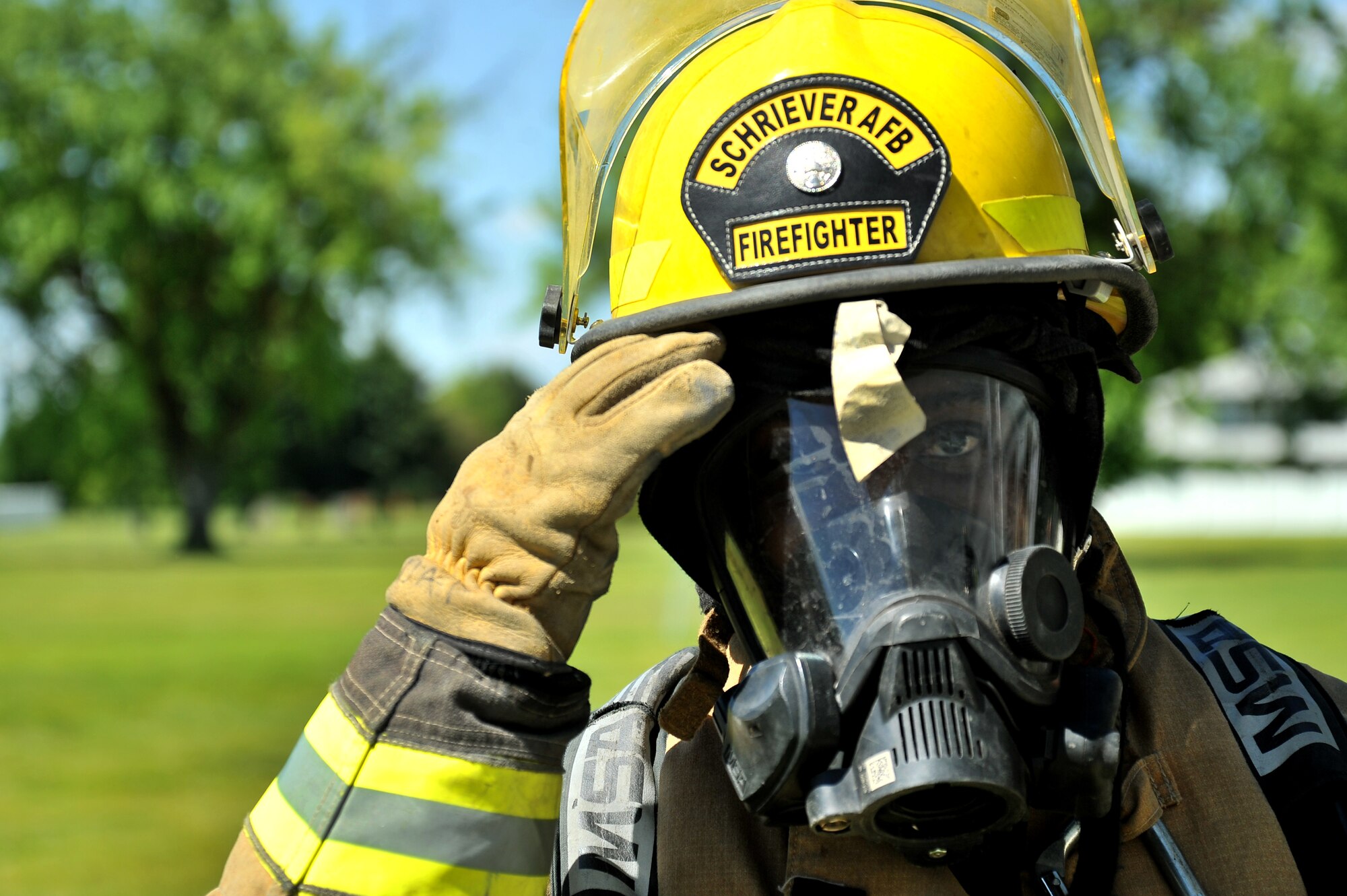 Dwayne Peeples, 50th Civil Engineer Squadron firefighter, begins to remove his protective gear after completing a one hour scenario blind folded to find a trapped firefighter during Rapid Intervention Team training at Fairchild Air Force Base, Wash., June 13, 2014. Fairchild hosted 14 Airmen from seven separate Fire Stations throughout the Air Force Space Command. Teams of two train together in buildings compiled with scenarios that help mimic the real life possibilities of being trapped, injured or lost. (U.S. Air Force photo by Staff Sgt. Alexandre Montes/Released)