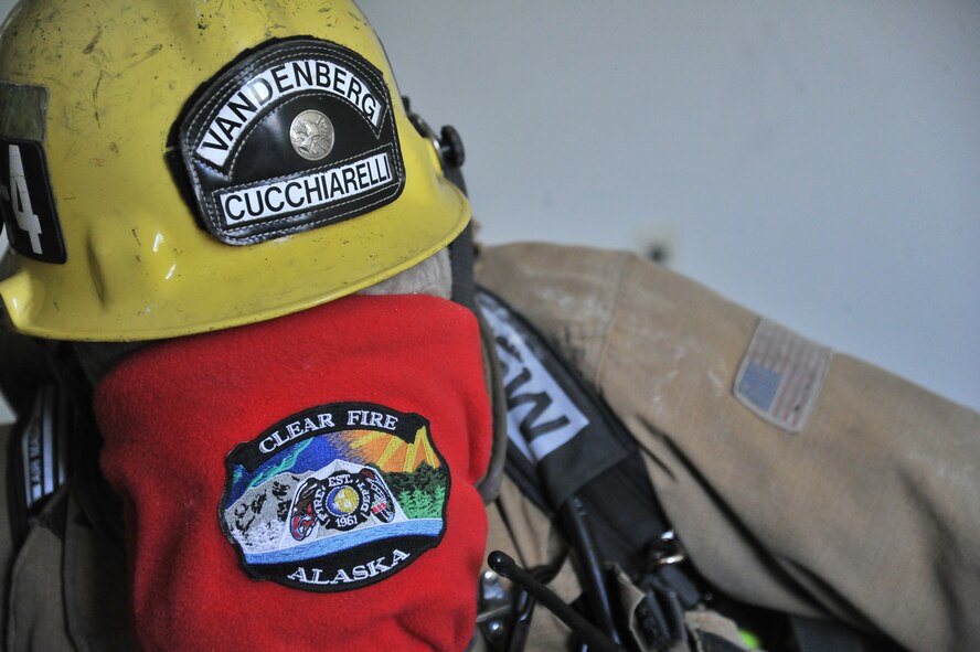 An airman from Vandenburg Air Force Base, California, stops to listen for a trapped firefighter while blindfolded during Rapid Intervention Team training at Fairchild Air Force Base, Washington, June 13, 2014. Fairchild hosted 14 Airmen from seven separate fire stations throughout the Air Force Space Command. Teams of two train together in buildings compiled with scenarios that help mimic the real life possibilities of being trapped, injured or lost. (U.S. Air Force photo/Staff Sgt. Alexandre Montes) 

