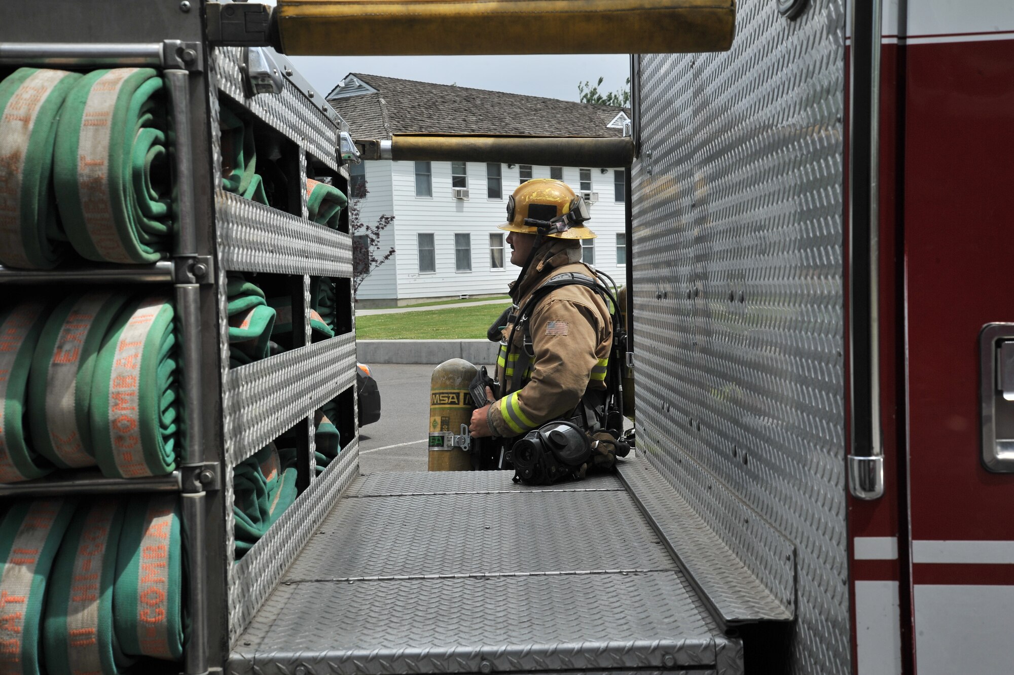A Fireman from the Air Force Space Command prepares the equipment to be used  for Rapid Intervention Team training at Fairchild Air Force Base, Wash., June 13, 2014. Fairchild hosted 14 Airmen from seven separate Fire Stations throughout the Air Force Space Command. Teams of two train together in buildings compiled with scenarios that help mimic the real life possibilities of being trapped, injured or lost. (U.S. Air Force photo by Staff Sgt. Alexandre Montes/Released)