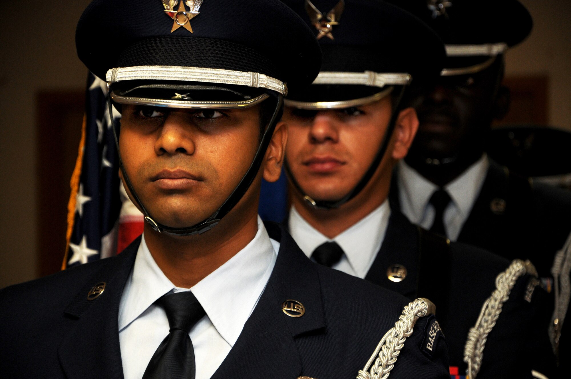 Senior Airman Pradeep Muddasani, left, Senior Airman Jesse Garcia Villanueva, middle, and Senior Airman Evens Perjuste, right, members of the 47th Flying Training Wing’s Honor Guard, stand at attention prior to the presentation of the colors at a Flag Day event hosted by the Benevolent and Protective Order of the Elks in Del Rio, Texas, June 14, 2014. Laughlin’s honor guardsmen perform at hundreds of ceremonies each year, both military and civilian, to preserve and honor the Air Force’s heritage and traditions. (U.S. Air Force Photo by Senior Airman Nathan Maysonet, 47th Flying Training Wing.) (Released)