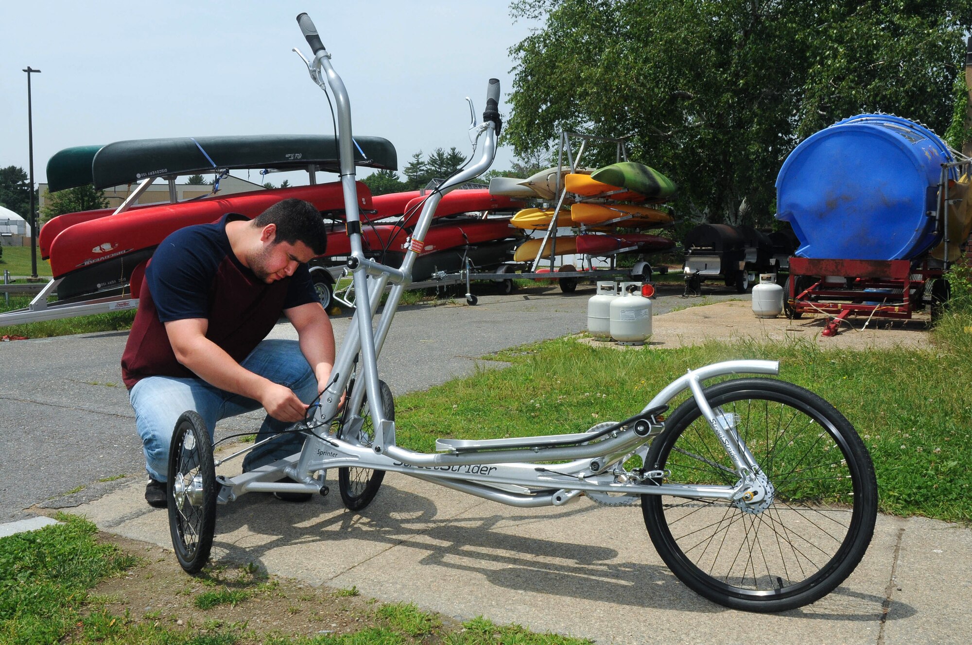 HANSCOM AIR FORCE BASE, Mass. - With the summer months here, Brian Guerra, 66th Force Support Squadron Outdoor Recreation specialist, prepares a Street Strider elliptical cross trainer for a rental June 17. Among the many items available at Outdoor Recreation are party equipment, water sports equipment, camping equipment, sports equipment and more. For further information on summer rentals, visit www.hanscomservices.com/OutdoorRecreation.asp. (U.S. Air Force photo by Mark Herlihy)