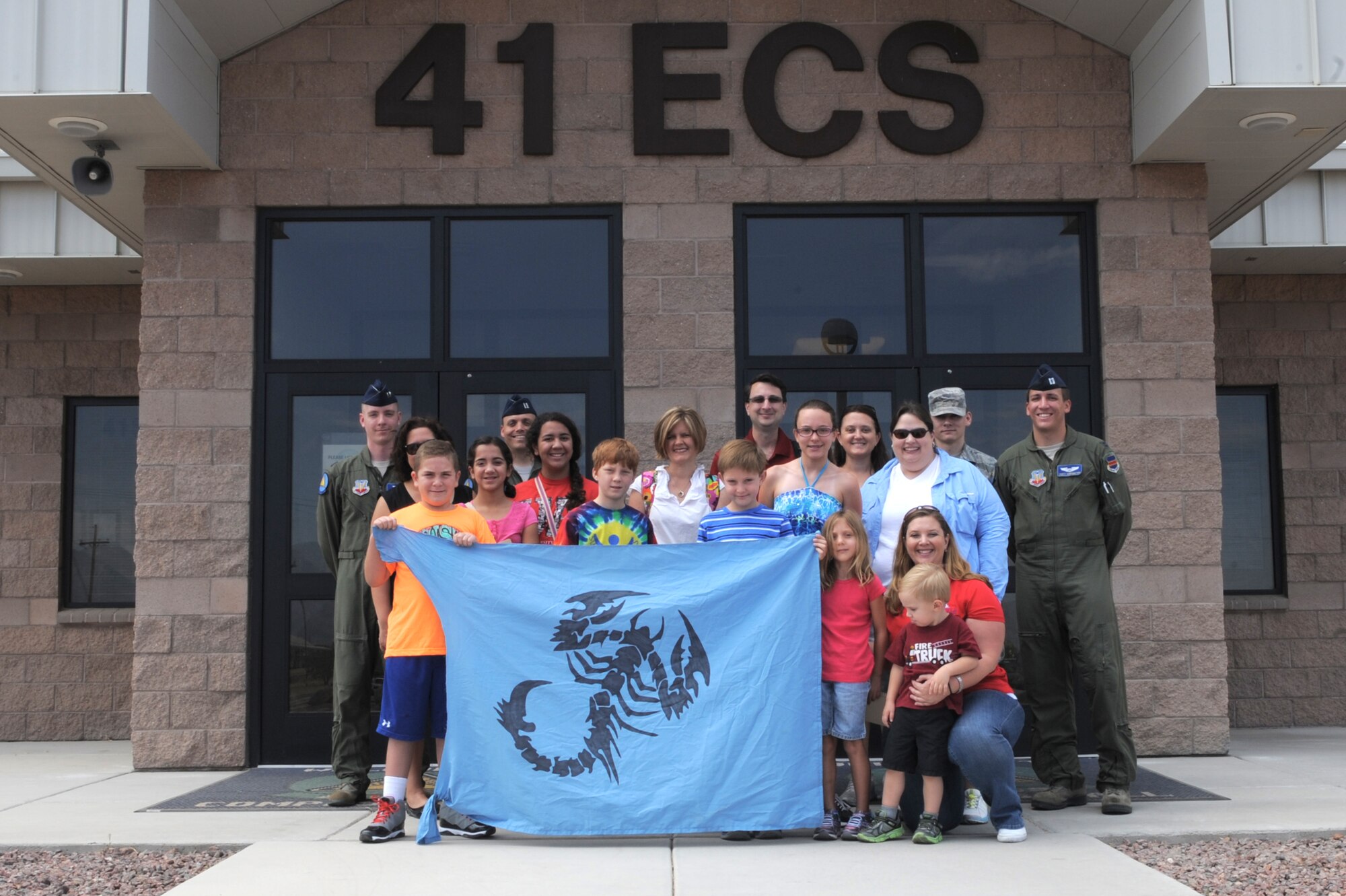 Patients from the University of Arizona Steele Children?s Research Center in Tucson, Ariz., pose for a group photo with 41st Electronic Combat Squadron personnel at Davis-Monthan Air Force Base, Ariz., June 12, 2014. The 41st ECS hosted a base tour for the patients that included an EC-130H static display, an interactive display of flight gear and a tour of D-M?s Fire Emergency Services fire house. (U.S. Air Force photo by Airman 1st Class Chris Drzazgowski/Released)