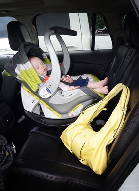 Placing a needed item such as a purse, wallet, lunch bag or uniform hat in the backseat is one way parents can avoid forgetting their child is with them. (Air Force photo illustration by Kelly White)