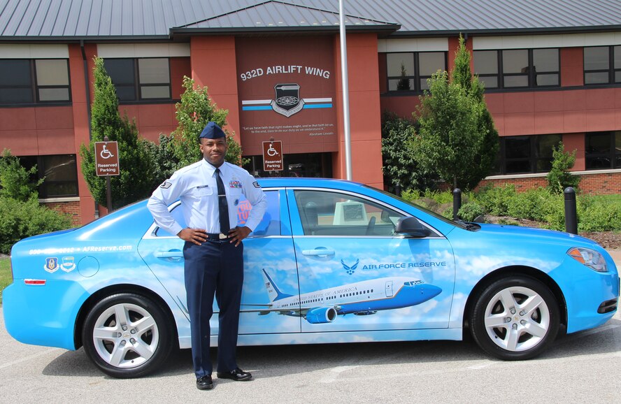 932nd Airlift Wing recruiter Staff Sgt. Keith Garrett proudly reveals the new Air Force Reserve Command recruiting vehicle that displays a C-40C.  (U.S. Air Force Photo/Staff. Sgt. Meiko Schill)