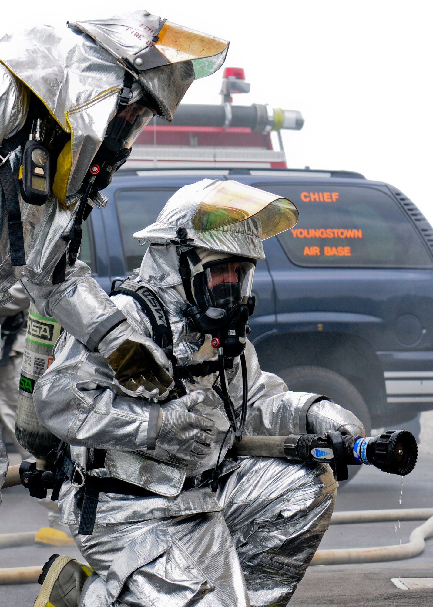 Firefighters from the 179th Airlift Wing, Mansfield Lahm Air National Guard Base, Ohio, check their gear before entering a structural fire simulation building for training here, June 18, 2014. More than 20 Mansfield firefighters came to Youngstown June 17-18 to complete annual training at the fire training area. The training included internal and external firefighting using an ignitable mock aircraft and firefighting inside a structural fire simulation building. U.S. Air Force photo/Eric M. White.