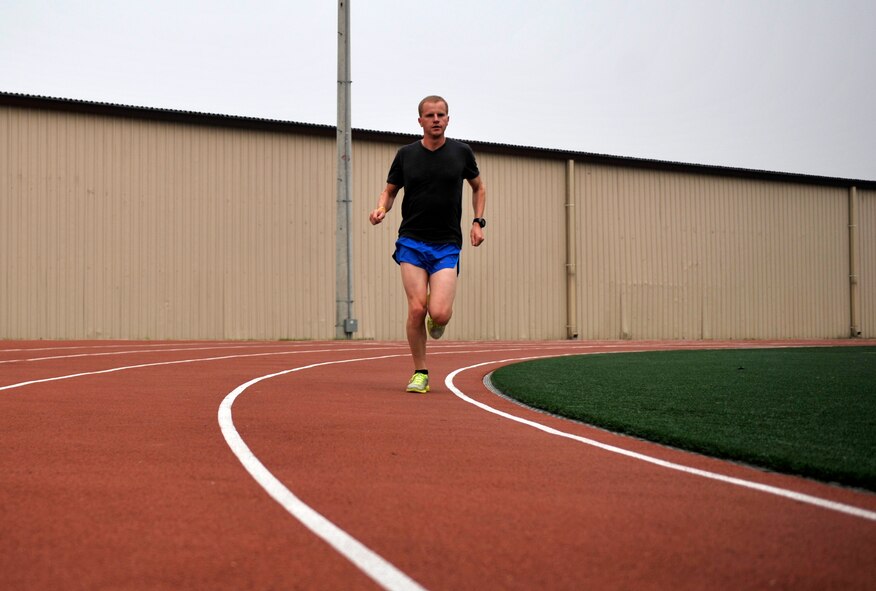 Airman 1st Class Andrew Riesenberger, 51st Civil Engineer Squadorn engineering technician, runs around the Mustang Track on Osan Air Base, Republic of Korea, June 17, 2014. Riesenberger has been selected to represent Pacific Air Forces in the upcoming Air Force Marathon. (U.S. Air Force photo/Senior Airman David Owsianka)