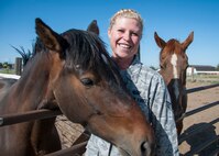 Senior Airman Jessica Kopecko poses with her favorite animal in the stables at Hill Air Force Base, Utah. Kopecko is a customer support journeyman in the 419th Force Support Squadron. As a civilian, she works as a farrier, working with horses’ hooves to improve their posture and balance. (U.S. Air Force photo/Staff Sgt. Crystal Charriere)