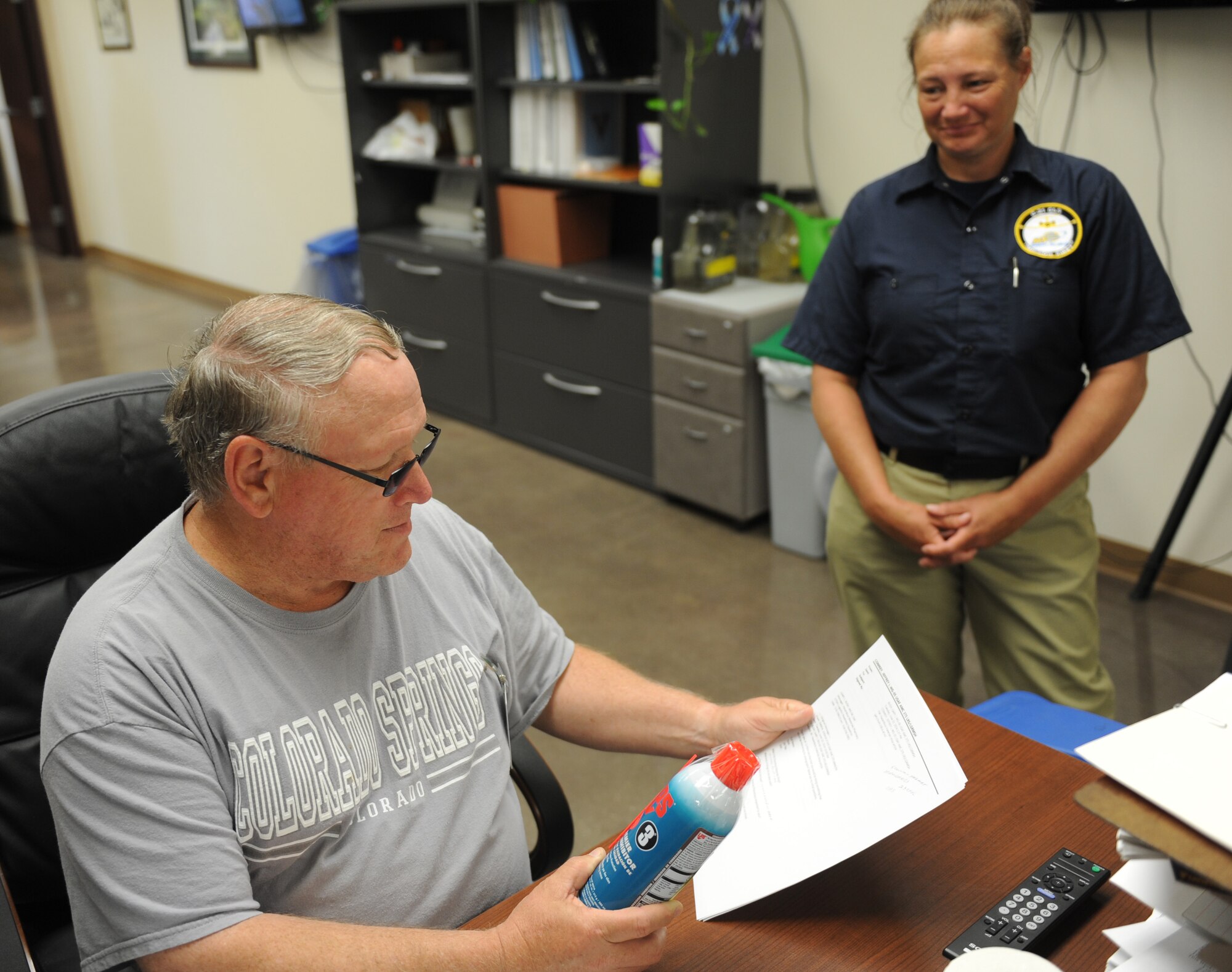 Jeff Comrey, 375th Logistics Readiness Squadron material handler, verifies a hazardous material (hazmat) by properly labeling it and providing the customer with the correct Safety Data Sheet in the HAZMART June 11, 2014 at Scott Air Force Base. Comrey and Bush work to make sure any hazmat on base has the correct safety documentation and expiration dates so it does not go to waste.( U.S. Air Force photo/ Senior Airman Joshua Eikren)