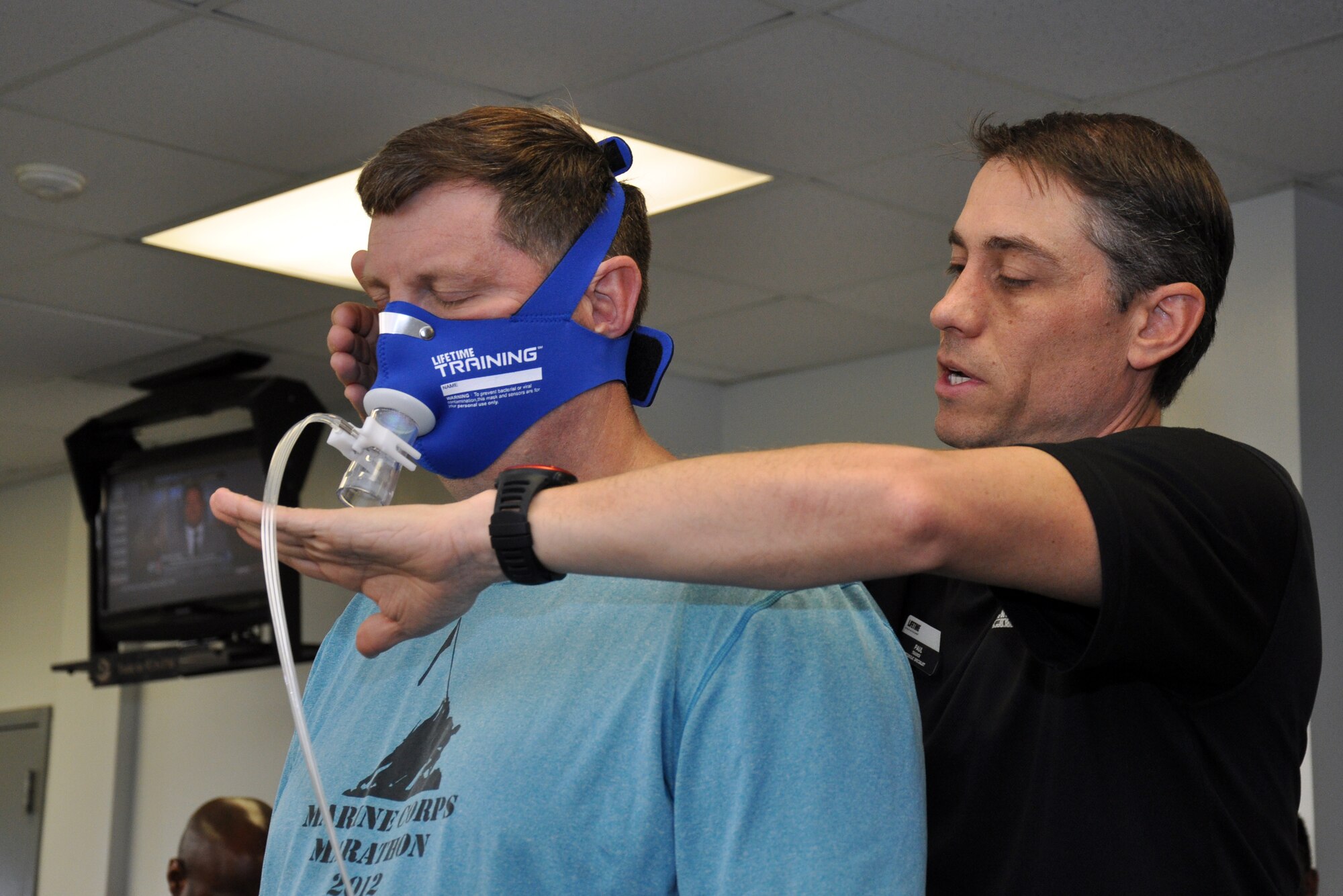 Col. Gregory Gilmour, 916th Air Refueling Wing commander, and Paul Bengds, fitness specialist, test a breathing mask while preparing for Gilmour’s metabolic test at the base gym recently. Bengds specializes in metabolic testing, which focuses on tailoring exercise regiments to the needs of different individuals. (U.S. Air Force photo/Staff Sgt. Alan Abernethy)