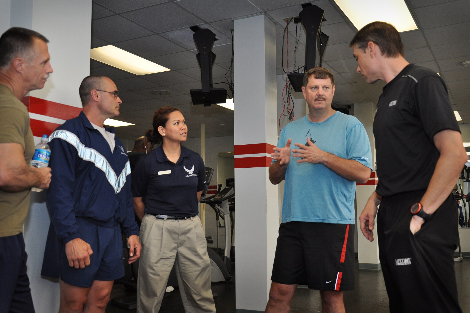 Col. Gregory Gilmour, 916th Air Refueling Wing commander, and Paul Bengds, fitness specialist, discuss methods to improve physical training efficiency at the base gym recently. 916th physical training leaders were also present to learn from Bengds, who specializes in tailoring exercise regiments to the needs of different individuals. (U.S. Air Force photo/Staff Sgt. Alan Abernethy)