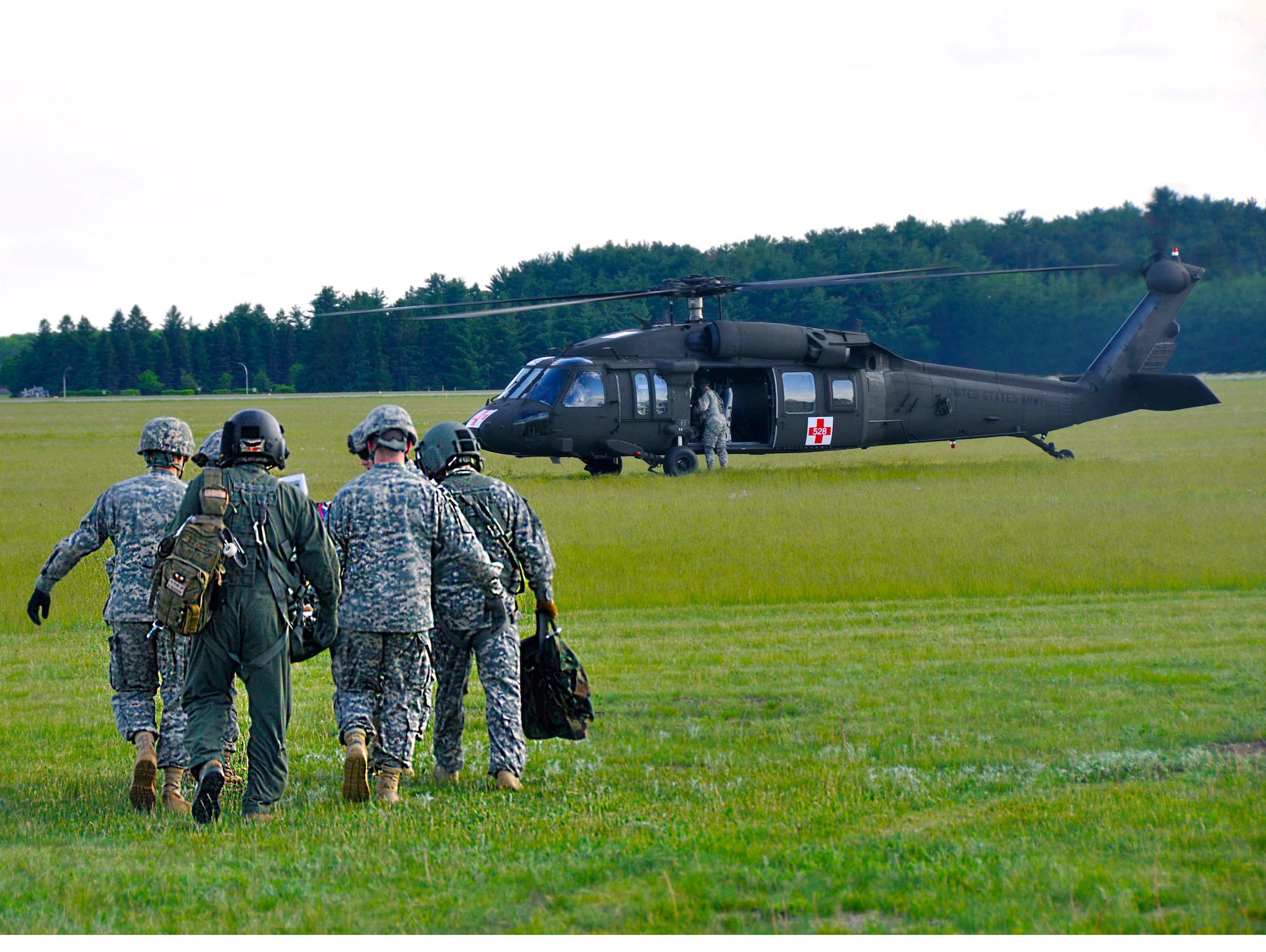 Carrying their fully packaged patient, the CCATT and Med Det members approach the Blackhawk for loading. (Air Force Photo/Senior Airman Jessica Coffin)