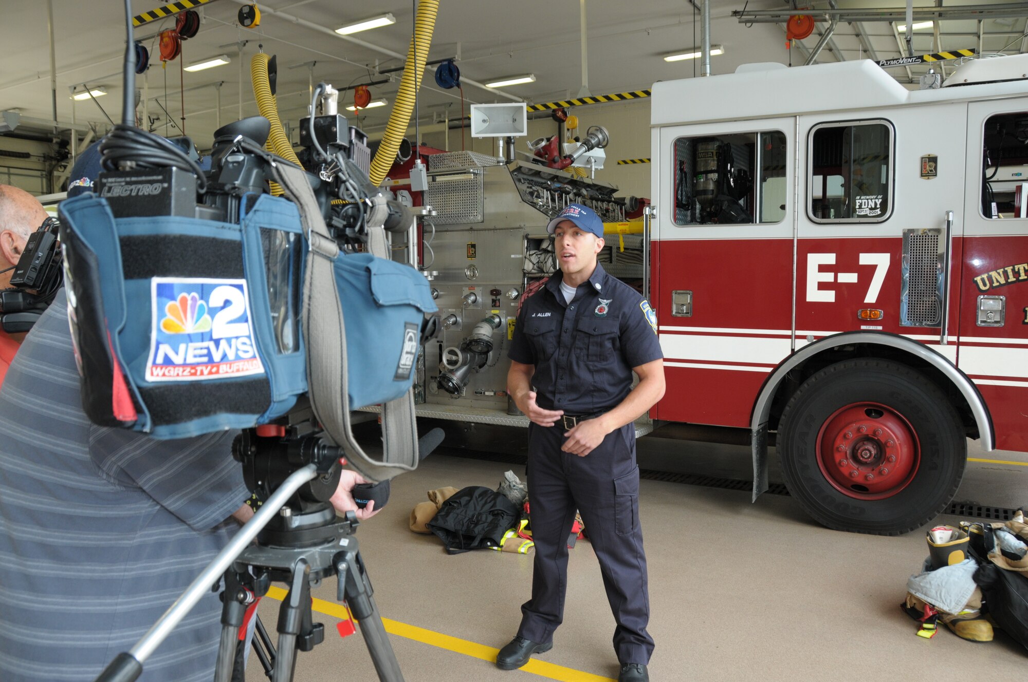Joseph Allen, 914th Fire Emergency Services Department of Defense civilian and Air Force Reserve Firefighter/Emergency Medical Technician, speaks with local media at the Niagara Falls Air Reserve Station, N.Y. on June 12, 2014 about lifesaving measures provided to a woman who was involved in a serious accident. Allen was off duty at the time and was one of the first people to respond to the accident. He treated the woman who required immediate medical intervention and as a result of his training and response doctors were able to preserve the woman's arm which was injured in the accident. (U.S. Air Force Photo by Peter Borys)
