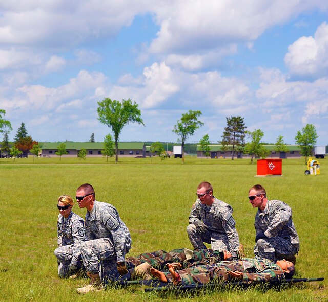 Army members prepare to lift their patient in a dry run before the rotors are put in motion.. (Air Force Photo/Senior Airman Jessica Coffin)